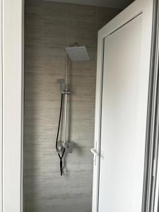 a light hanging from a wall next to a door at Hotel okriba in Tqibuli