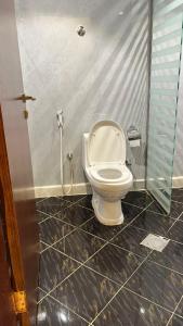 a bathroom with a toilet and a shower at Fakher Yanbu Hotel in Yanbu +32 photos