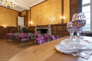 a room with a table and chairs and a christmas tree at Schloss Westerholt in Herten