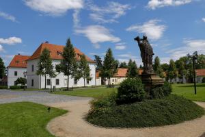 a statue of a man on a fountain in front of a building at Adalbert Ecohotel in Prague +28 photos