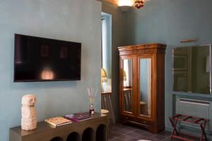 a living room with a tv on the wall at Palazzo Presta in Gallipoli