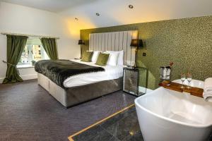 a bedroom with a large bed and a bath tub at The Borough Lancaster in Lancaster