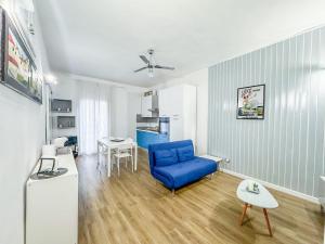 a living room with a blue chair and a table at Luxury Allegra’s home in Syracuse