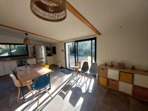 a kitchen with a table and chairs in a room at Au coeur des vignes in Grospierres