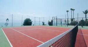 a tennis court with a net on top of it at Lubina del Sol beachfront in Sitio de Calahonda