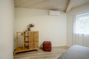 a bedroom with a bed and a wooden ceiling at Sea Bees vacation homes in Ragaciems