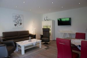 a living room with a couch and a table at Cutty Sark in Norden
