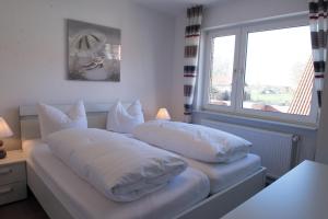 two pillows on a bed in a room with a window at Bounty in Norden