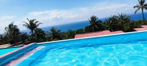 a swimming pool with a view of the ocean at pulau weh sabang Coco jungle in Sabang