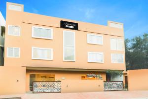 an orange building with a sign on it at Super Townhouse Viraj Khand Formerly Veridian Inn in Lucknow
