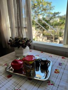 a tray of food on a table in front of a window at Casa de família na Serra Gaúcha in Bento Gonçalves