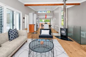 a living room with a couch and a glass table at Sea Point Luxury Escape with Private Pool in Cape Town