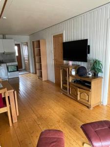 a living room with a flat screen tv on a table at Ranchen in Sortland +7 photos