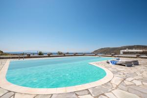 a swimming pool with a view of the ocean at Beachfront House 50m from the beach in Mykonos