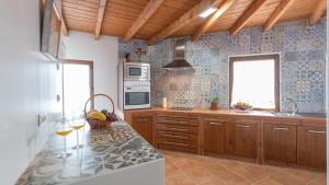 a kitchen with wooden cabinets and a counter top at Casa Mis Niñas Casabermeja by Ruralidays in Casabermeja