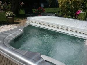 a pool of water in a hot tub at La roseraie in Aytré