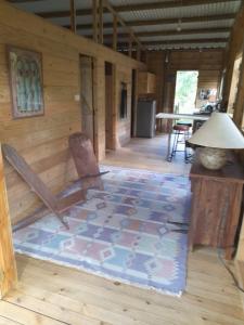 a room with a wooden floor with a chair and a lamp at Laferm Coco in Grand Sable +34 photos