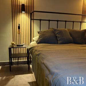 a bedroom with a bed and a table with a lamp at B & B In Two Hulten in Hulten