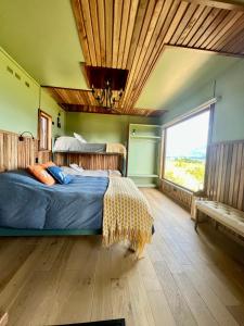 a bedroom with a bed and a large window at Panguipulli Bella Vista in Panguipulli