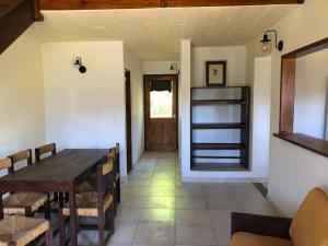 a dining room with a wooden table and chairs at Claro de Luna 2 in Villa Gesell