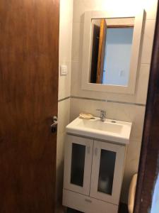 a bathroom with a sink and a mirror at Claro de Luna 2 in Villa Gesell +2 photos