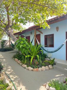 a house with a garden in front of it at Recanto do cajueiro in Flecheiras