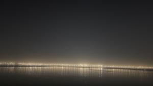 a large body of water with a city in the background at Prayagraj Sangam Homestays in Naini