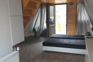 a bedroom with a large bed and a staircase at 2brCabin-Fireplace-HotTub-Sauna-SkiResort in Bran