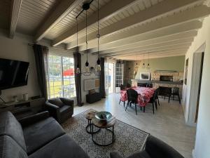 a living room with a couch and a dining room at Pors Ar Vag in Plomodiern