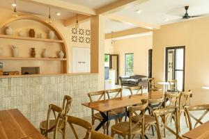 a dining room with wooden tables and chairs at Casa Nala Calicoan - Family Room in Guiuan