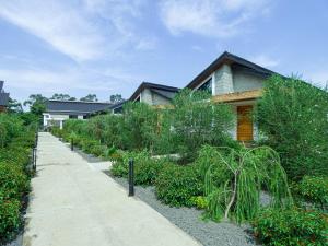 una casa con jardín junto a una acera en Ritzy Arcadia Cottages, en Arusha