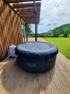 a large tire sitting on a wooden deck at New Villa by the sea in Hervik, Spa and boat rental in Tysvær