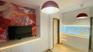 a living room with a flat screen tv on a wall at Свети Йоан in Sozopol