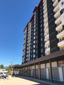 a black apartment building with a parking lot at Estar Poético in Temuco