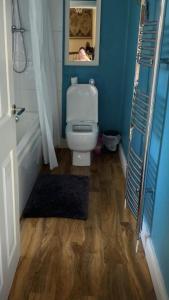 a bathroom with a white toilet and a bath tub at Tranquil Darlington Home 3BR Pet Friendly in Darlington +2 photos
