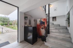 a staircase in a house with a painting on the wall at Studios Anais in Limenas
