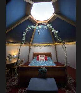 a bedroom with a bed in a room with a ceiling at daisy meadow in Upton upon Severn +9 photos