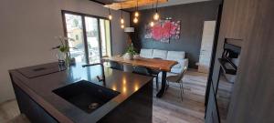 a kitchen and living room with a dining room table at Il nido tra gli ulivi in Lucinasco +26 photos
