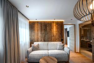 a living room with a couch and a wooden wall at Villa Pana in Santa Cristina Gherdëina