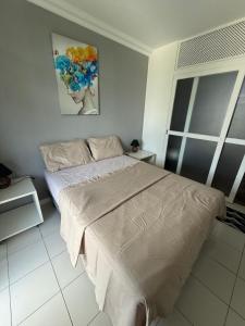 Un dormitorio con una cama y un cuadro en la pared. en Camboinhas - Piscina e Garagem na Rua da praia, en Niterói 32 fotos más