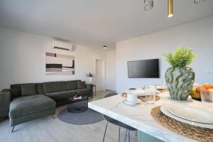a living room with a couch and a table at Imola's Place - Sea-View & Pool in Slatine