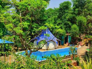 a resort with a swimming pool and a house at The Lotus Resort Lonavala in Āmbavna