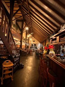 a restaurant with a bar and some tables and chairs at Herberg Sellingen in Sellingen