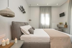 a bedroom with a bed and a table with candles at Villa Bazeos in Agkidia +111 photos