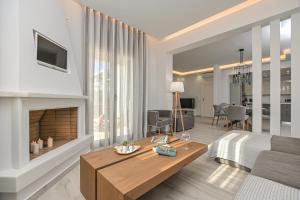 a living room with a bed and a fireplace at Villa Bazeos in Agkidia