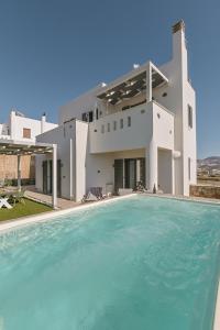 a house with a swimming pool in front of a house at Villa Bazeos in Agkidia