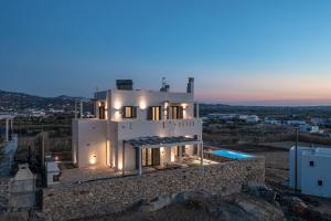 a villa with a view of the city at dusk at Villa Bazeos in Agkidia
