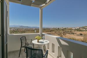 a balcony with a table and chairs and a view at Villa Bazeos in Agkidia