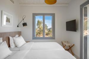 Ένα ή περισσότερα κρεβάτια σε δωμάτιο στο Urania Luxury Villa Rhea