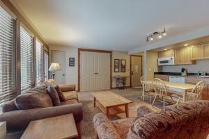 a living room with a couch and a table at Tranquil Pines at Seventh Mountain in Bend